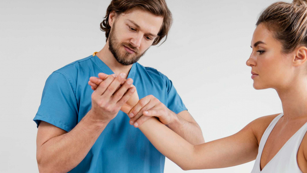 male-osteopathic-therapist-checking-female-patient-s-wrist (1).jpg