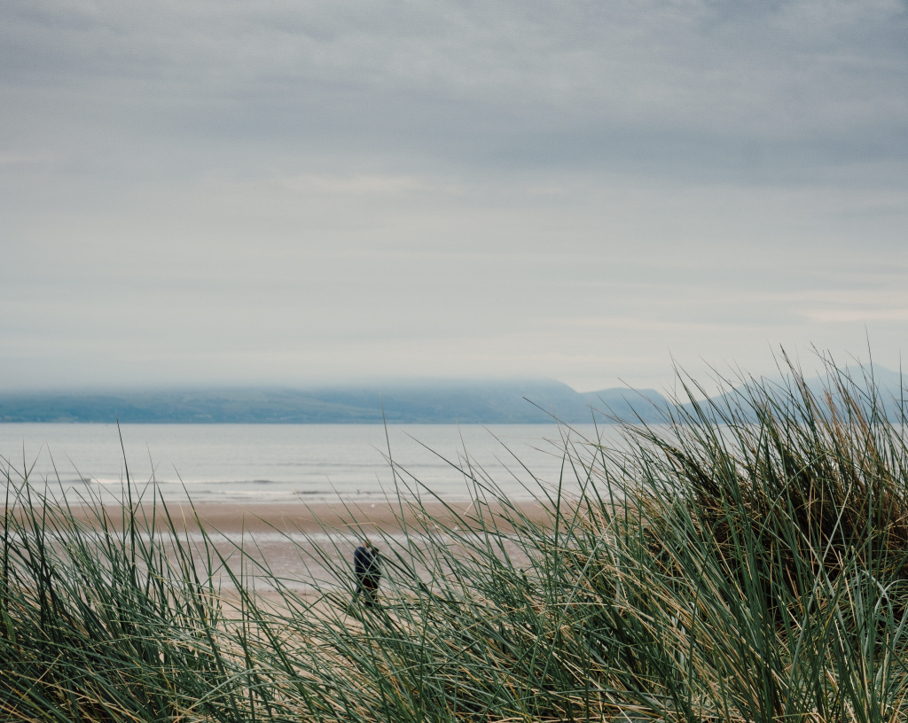 shot-from-beach-gloomy-day-man-walking-by-shore (1).jpg